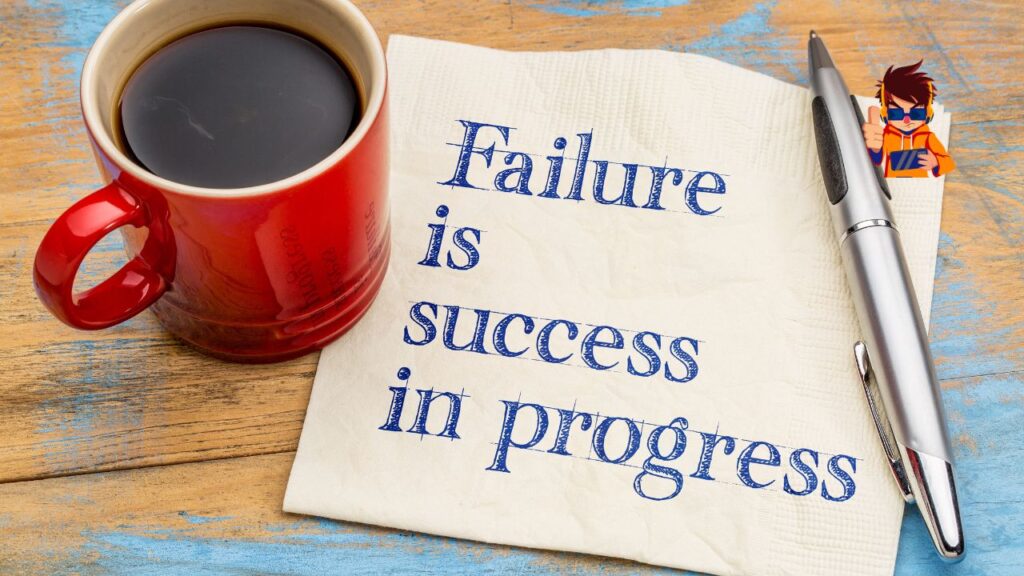 A red coffee cup, a silver pen, and a napkin with the handwritten quote 'Failure is success in progress' placed on a rustic wooden table. The image symbolizes resilience, learning from setbacks, and turning failures into opportunities for success.